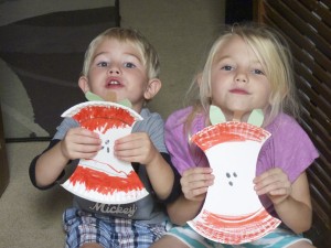 kids holding apple core craft