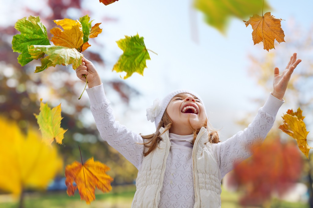 Girl catching falling leaves